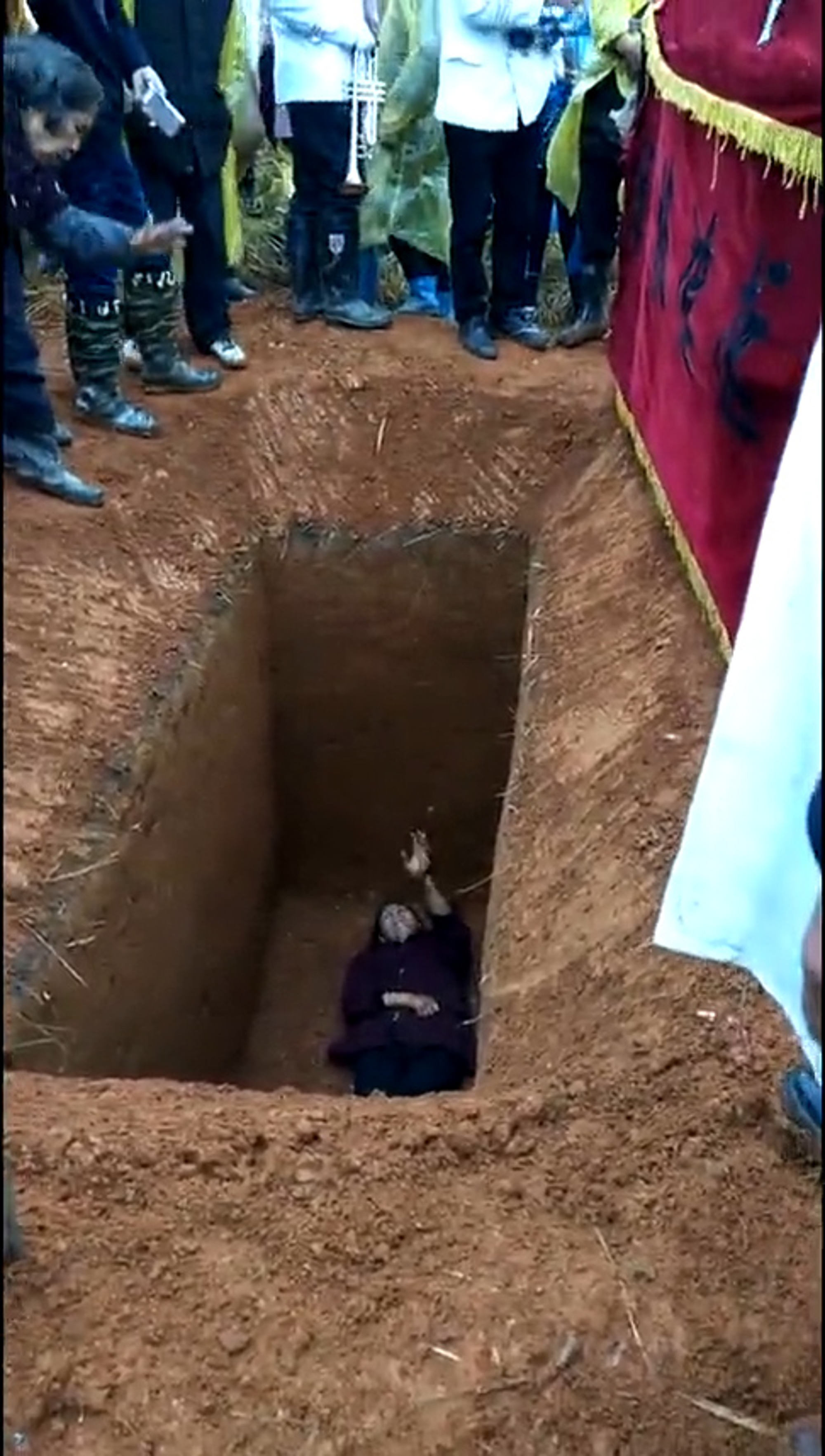 Read more about the article Woman Occupies Grave In Funeral Rites Protest