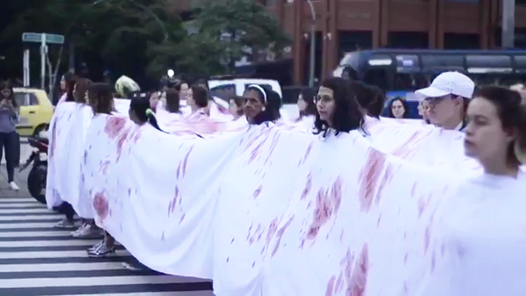 Read more about the article Feminists Protest In Huge Bloodied Sheet On Womens Day