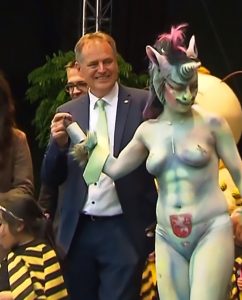 Read more about the article Mayor Takes Topless Councillor In Unicorn Getup To Fete