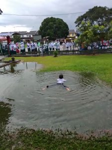Read more about the article Boy Swims In Puddle In School Uniform