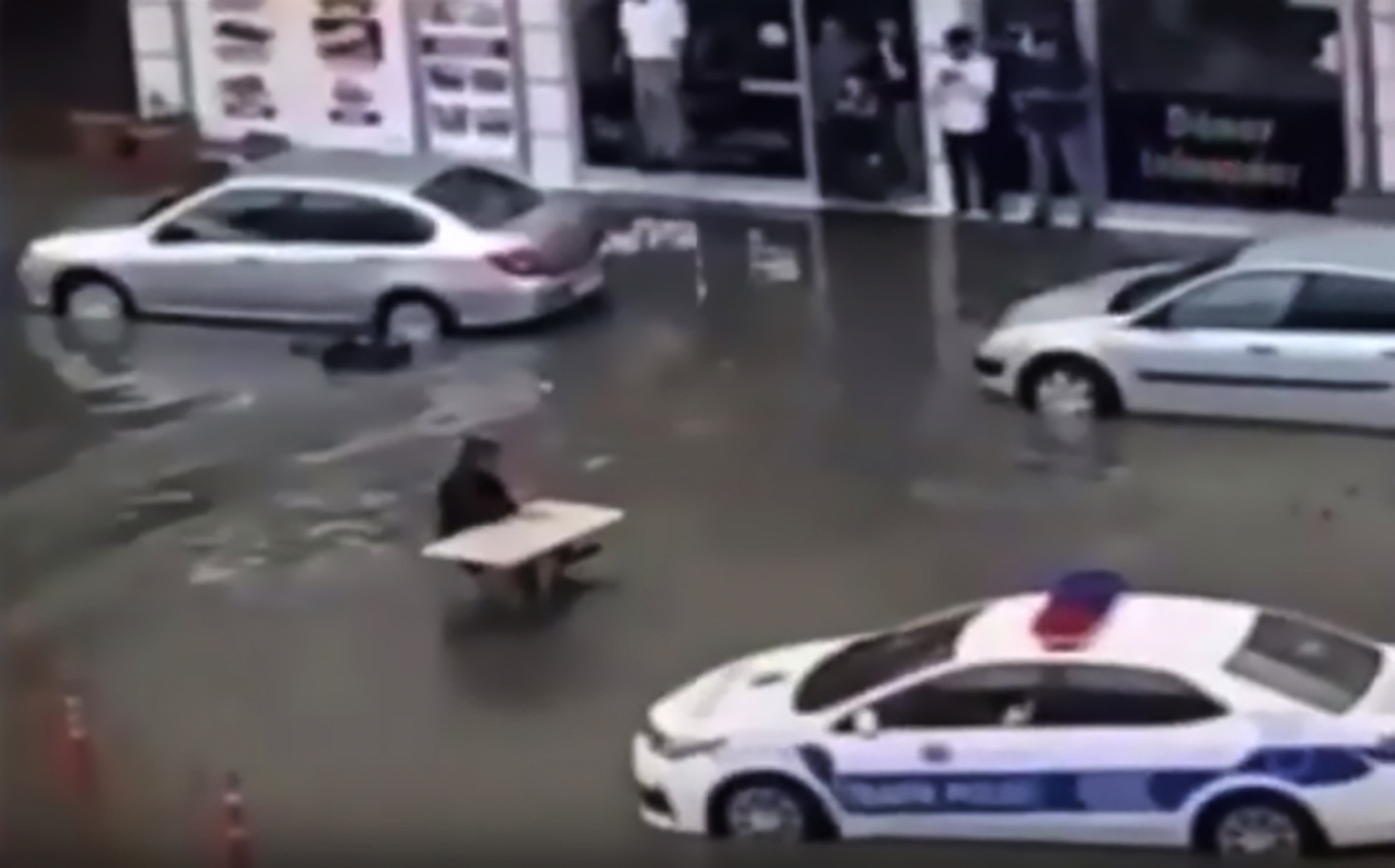 Read more about the article Man Eats Soup At Table In Middle Of Flooded Street