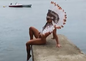 Read more about the article Miss BumBum Poses On Pier In Thong And Native Headdress