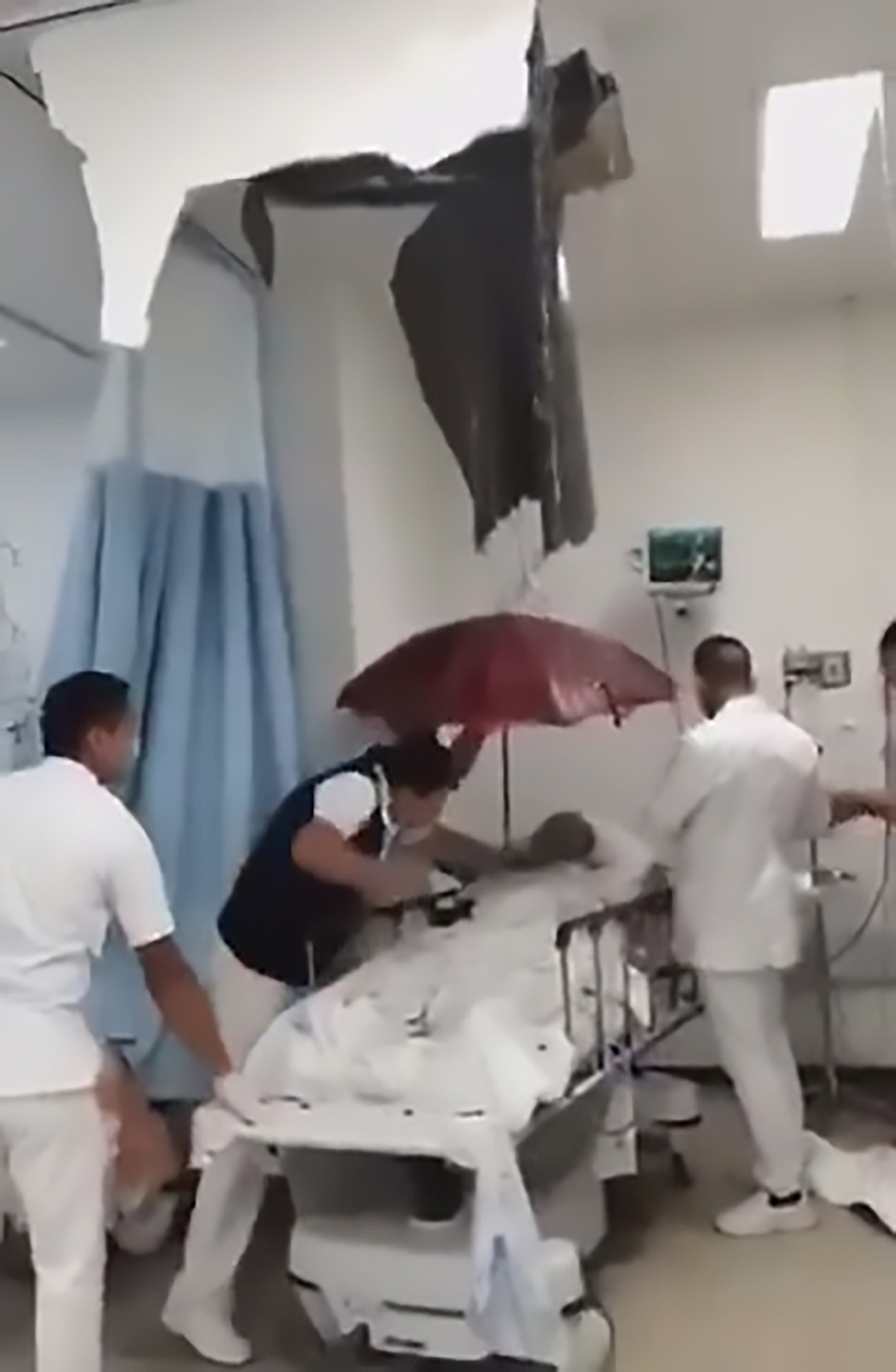 Read more about the article Docs Hold Umbrella Over Hospital Patient As Water Pours In