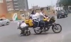Read more about the article No Helmet Couple On Motorbike Drag Baby Pram Behind Them