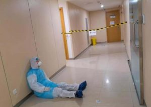 Read more about the article Coronavirus Dr Sleeps Against Wall After 20-Hour Shift