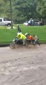 Read more about the article Man Clings To Motorbike Swept Along Flooded Street