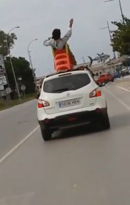 Read more about the article Tourist Sits In Kids Slide Strapped To Top Of Moving Car