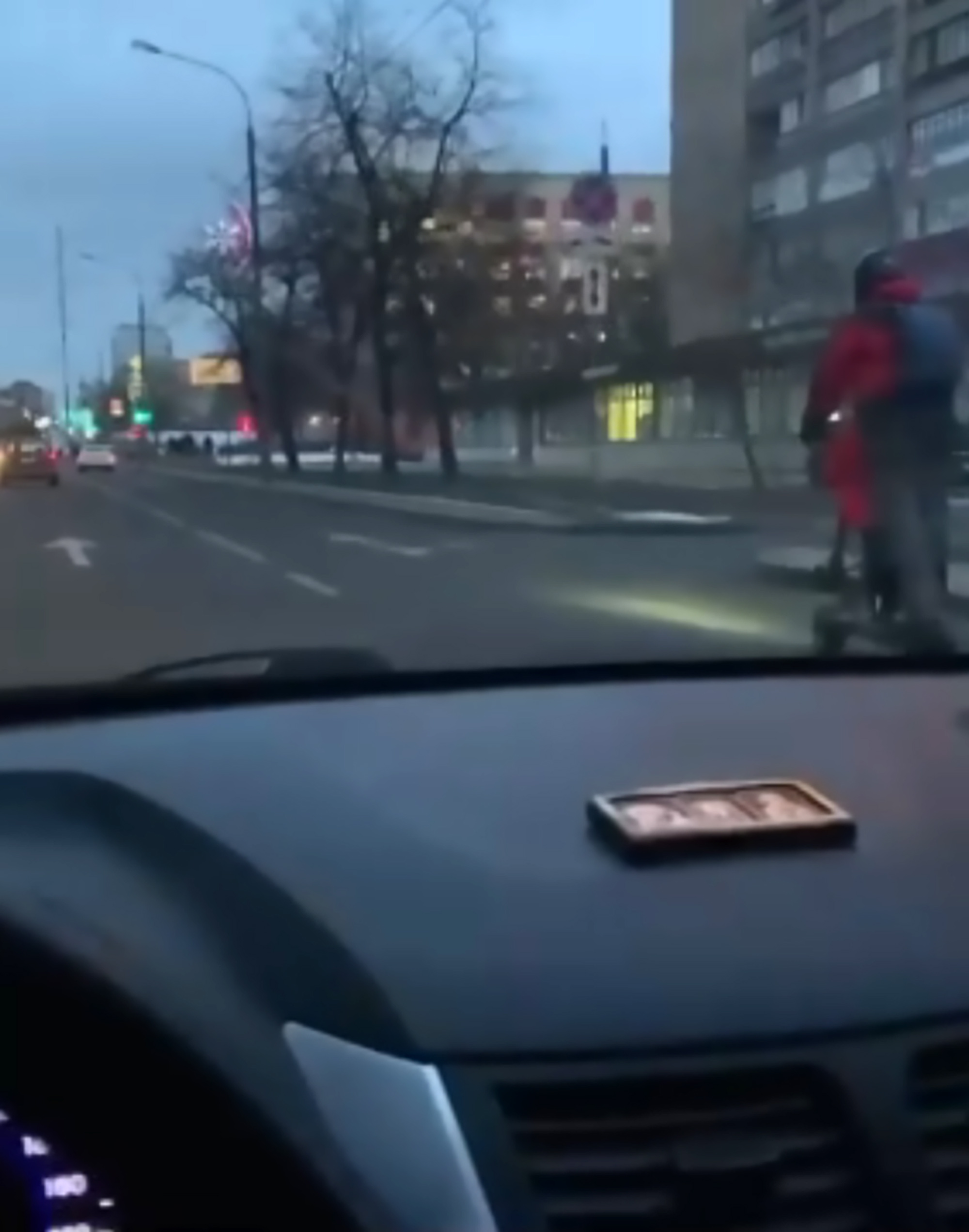 Read more about the article Man Rides Scooter On Busy Road With Kid Stood At Front