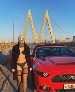 Read more about the article Athlete Walks On Empty Bridge In Lingerie And Gas Mask