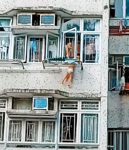 Read more about the article Moment Tot Dangles Outside Flat Window