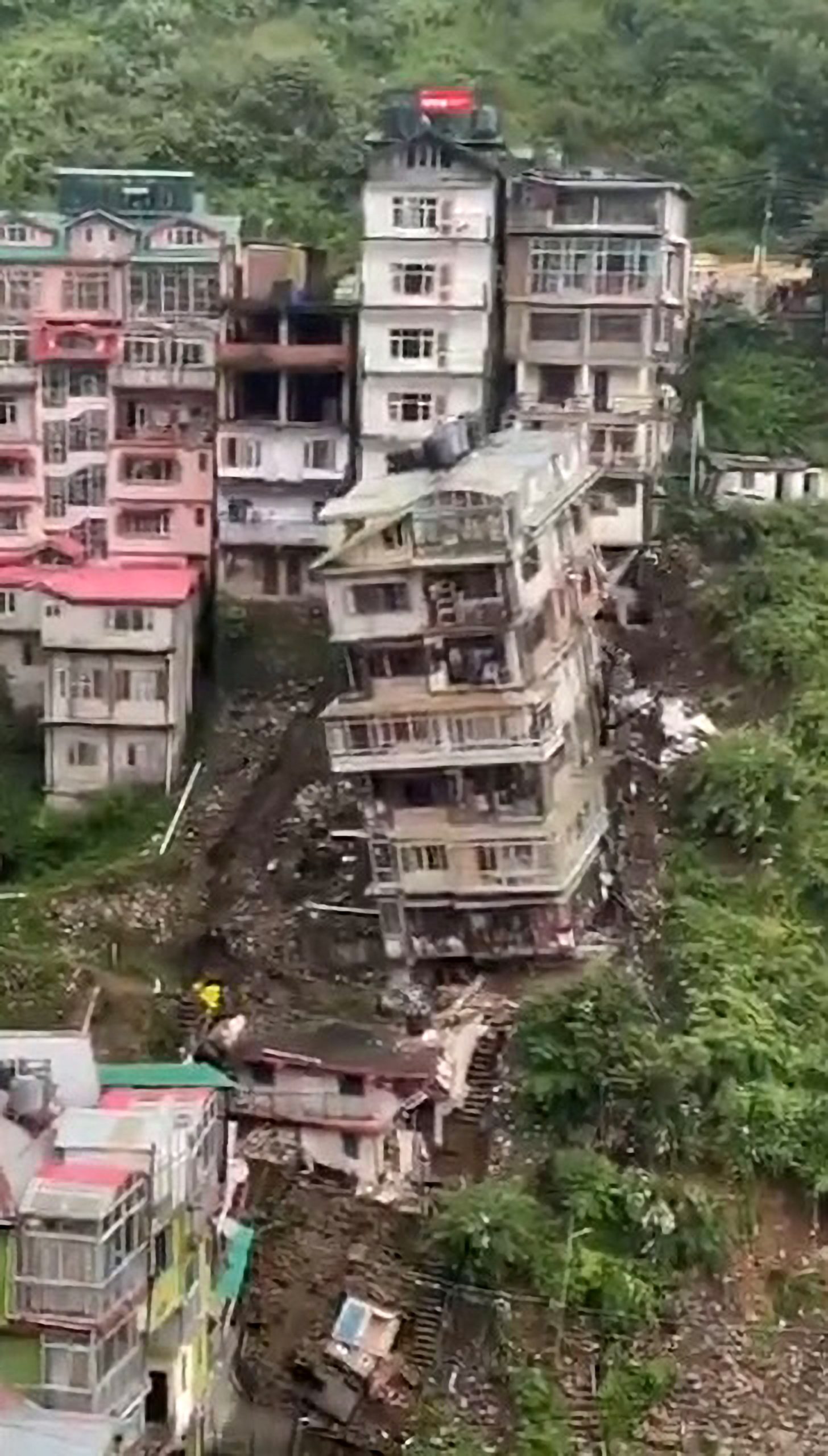 Read more about the article Moment Shaky Old Apartment Block Collapses Down Hill After Indian City Hit By Landslides