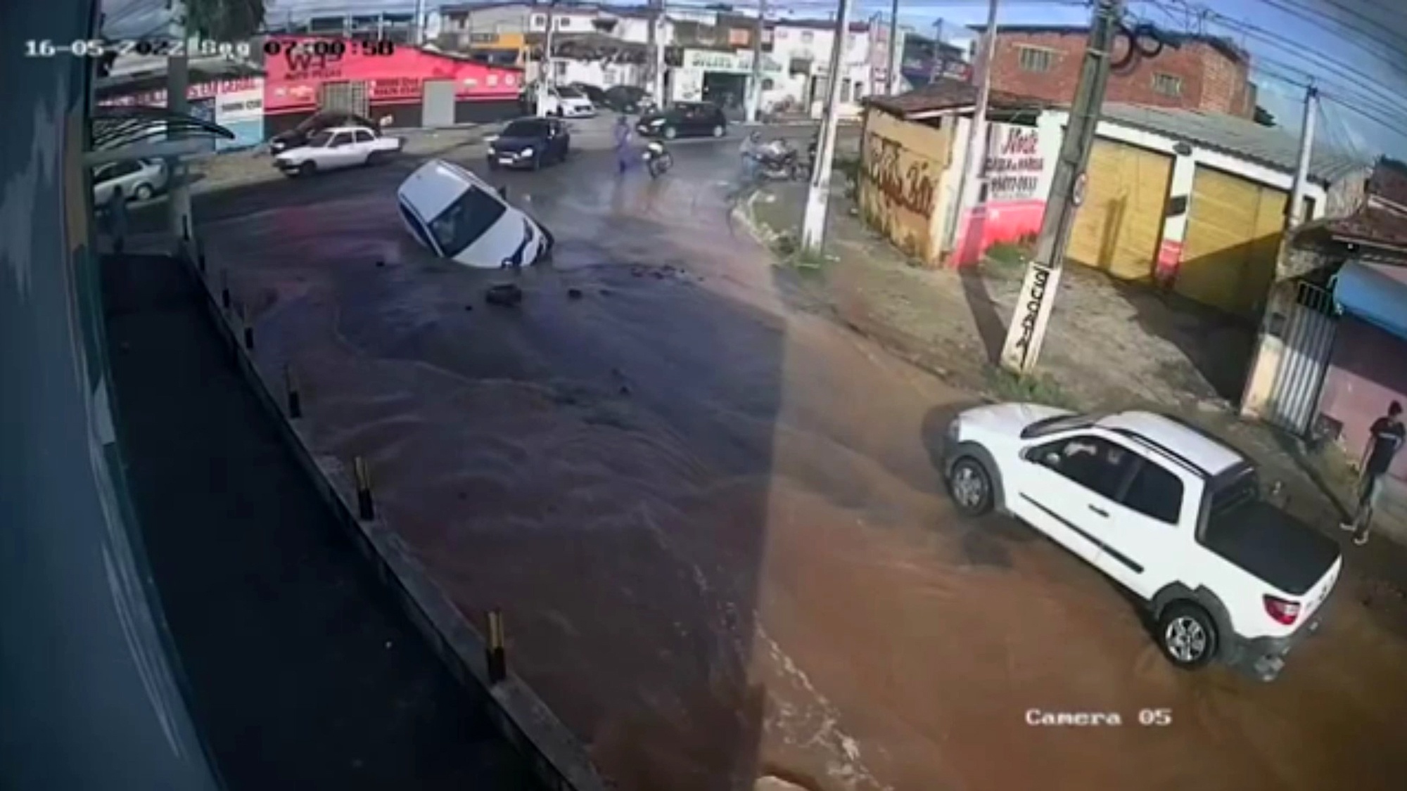 Read more about the article WATER DISASTER: Car Sinks In Huge Hole In Street Hidden By Water