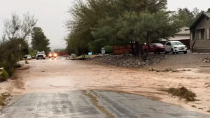 Read more about the article WASHED OUT: Rain Swollen River Washes Over Arizona Street Following Heavy Rain